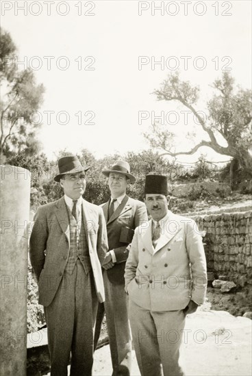 Visiting the ruins of Ashkelon. William Ryder McGeagh (centre), District Commissioner in Jerusalem, visits the ancient walled city of Ashkelon with two men in suits. Near Ashqelon, British Mandate of Palestine (Israel), circa April 1938. Ashqelon, South (Israel), Israel, Middle East, Asia.