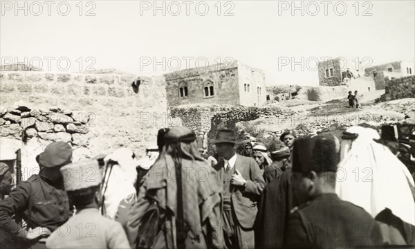 Tax collection in Idna. A British government official collects taxes in the Arab village of Idna. Idna, British Mandate of Palestine (West Bank, Middle East), 1939. Idna, West Bank, West Bank (Palestine), Middle East, Asia.