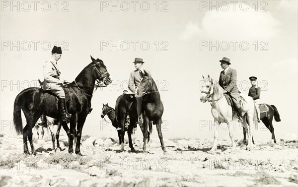 British officials ride out to meet Arab leaders. A delegation of British officials rides out across rocky ground to meet Arab leaders at a camp in the desert. British Mandate of Palestine (Israel), circa 1940. Israel, Middle East, Asia.
