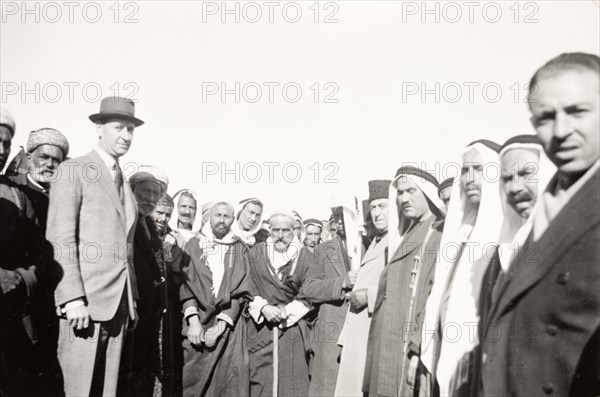 William Ryder McGeagh meets Arab villagers. William Ryder McGeagh (centre), District Commissioner in Jerusalem, poses for the camera with a crowd of Arab men whilst visiting a rural Arab village. British Mandate of Palestine (Israel), circa 1940. Israel, Middle East, Asia.