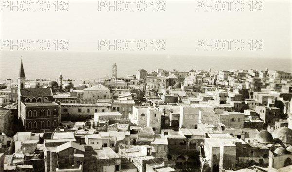 The old city of Acre. View across the old port city of Acre, looking out over the Bay of Acre. Notable landmarks include the 17th century Franciscan Terra Sancta Church (far left), the 18th century Al Jezzar Mosque (discernable by its tall minaret) and the Ottoman citadel (centre, overlooking the coast). Acre (Akko), British Mandate of Palestine (Northern Israel), circa 1940. Akko, North (Israel), Israel, Middle East, Asia.