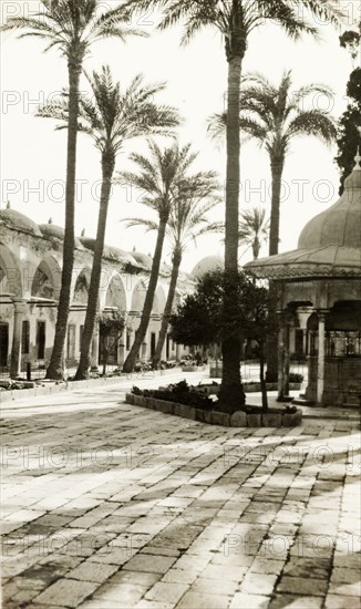 Purification fountain in Acre. A purification fountain sits outside a colonnade at the entrance to the 18th century Al Jezzar Mosque. Acre (Akko), British Mandate of Palestine (Northern Israel), circa 1940. Akko, North (Israel), Israel, Middle East, Asia.