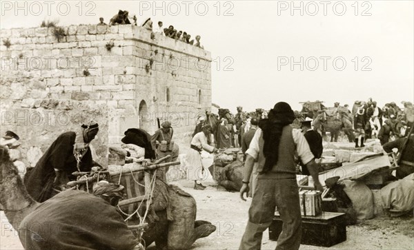 Preparing for a journey to Al-Masfara. A party of travellers prepares to embark on a journey to Al-Masfara, a mountainous region to the west of the Dead Sea. Bani Naeem, British Mandate of Palestine (West Bank, Middle East), April 1941. Bani Naeem, West Bank, West Bank (Palestine), Middle East, Asia.