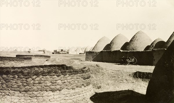 Bedouin mud dwellings near Aleppo. A Bedouin village near Aleppo, containing a number of beehive-shaped adobe mud dwellings. Near Aleppo, French Mandate of Syria (Syria), 1941. Aleppo, Syria, Syria, Middle East, Asia.