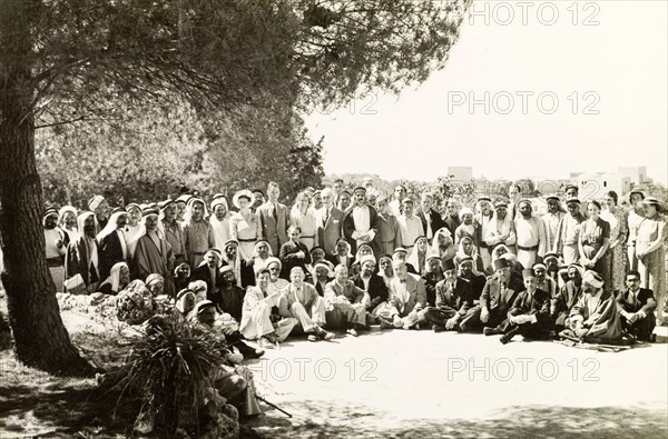 Arab mukhtars at a District Commissioner's party. A large group of Arab mukhtars (headmen) pose for a group portrait with British officials and their wives at a party organised by the District Commissioner. Qubeiba, British Mandate of Palestine (West Bank, Middle East), 1941. Qubeiba, West Bank, West Bank (Palestine), Middle East, Asia.
