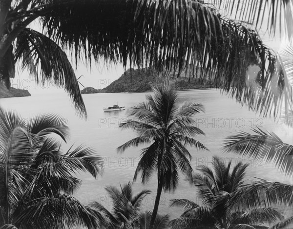 A lagoon on Yanuya Island. A large motor boat provides a cruising service across a lagoon on Yanuya Island. Mamanuca Archipelago, Fiji, 1965. Fiji, Pacific Ocean, Oceania.