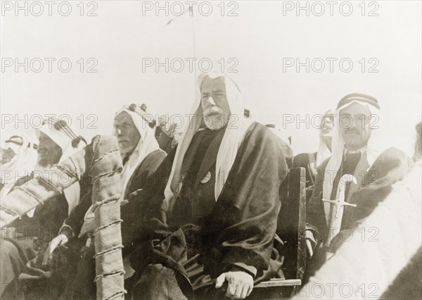 The Mayor of Be'er Sheva watches a camel race. The Mayor of Be'er Sheva, Sheikh Taj ed Din es Sha'ath, sits on a raised dais with other Arab dignitaries as he watches a camel race. Be'er Sheva, British Mandate of Palestine (South Israel), 27 February 1944. Be'er Sheva, South (Israel), Israel, Middle East, Asia.