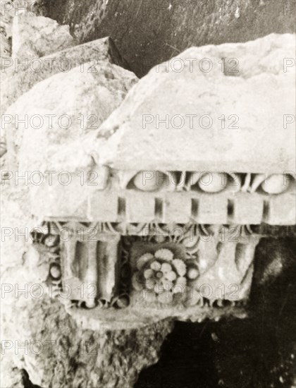 A carving amidst the ruins. A fragment of a carved stone capital lies amidst the Roman ruins at Baalbek, once one of the largest colonies in the Roman Empire and originally known as Heliopolis. Baalbek, French Mandate of Lebanon (Lebanon), April 1944. Baalbek, Beqaa, Lebanon, Middle East, Asia.