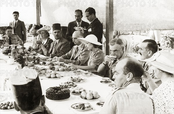 Farewell lunch for Sir Harold MacMichael. Sir Harold MacMichael (centre), High Commissioner of the British Mandate of Palestine, attends a farewell lunch with government officials. MacMichael had survived an assassination attempt only four days prior to this photograph, and subsequently left Palestine on 31 August. Probably Jerusalem, British Mandate of Palestine (Israel), 12 August 1944. Jerusalem, Jerusalem, Israel, Middle East, Asia.