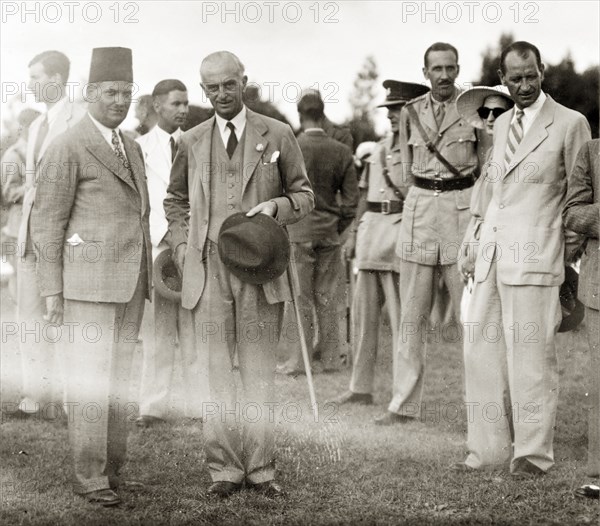 Farewell party for Sir Harold MacMichael. Sir Harold MacMichael (second from left), High Commissioner of the British Mandate of Palestine, mingles with government officials at his farewell party. MacMichael had survived an assassination attempt only four days prior to this photograph, and subsequently left Palestine on 31 August. Probably Jerusalem, British Mandate of Palestine (Israel), 12 August 1944. Jerusalem, Jerusalem, Israel, Middle East, Asia.