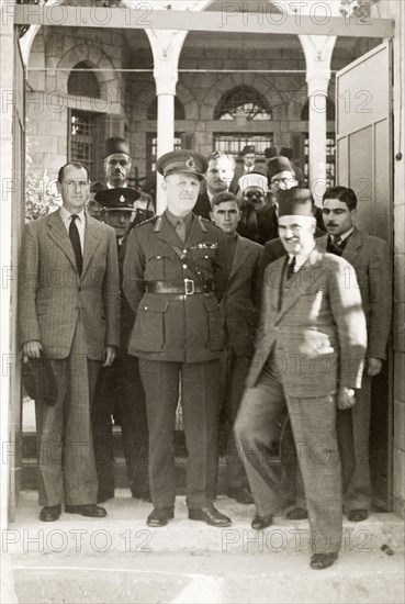 Lord Gort visits Gaza. Lord Gort (centre), the newly appointed High Commissioner of Palestine and Transjordan, poses for photographers with British and Arab officials. To his right stands William Ryder McGeagh, District Commissioner in Jerusalem. Gaza, British Mandate of Palestine (Gaza Strip, Middle East), 4 December 1944. Gaza, Gaza Strip, Gaza Strip (Palestine), Middle East, Asia.