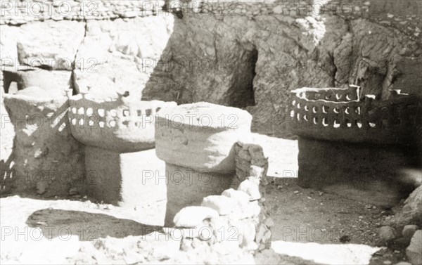 Cargo containers at Luxor docks. Clay posts with pierced caps sit in the sun at Luxor docks. Related images and captions suggest these may be containers used to protect cargo against scorpions before transit. Luxor, Egypt, February 1947. Luxor, Qina, Egypt, Northern Africa, Africa.