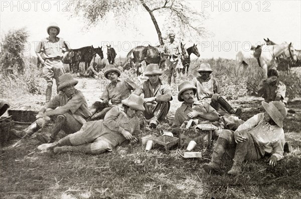 Men from the Police Training School. A group of men from the Police Training School at Moradabad stop for a break beneath a shady tree during a pig sticking hunt. Near Moradabad, United Provinces (Uttar Pradesh), India, circa 1933. Moradabad, Uttar Pradesh, India, Southern Asia, Asia.