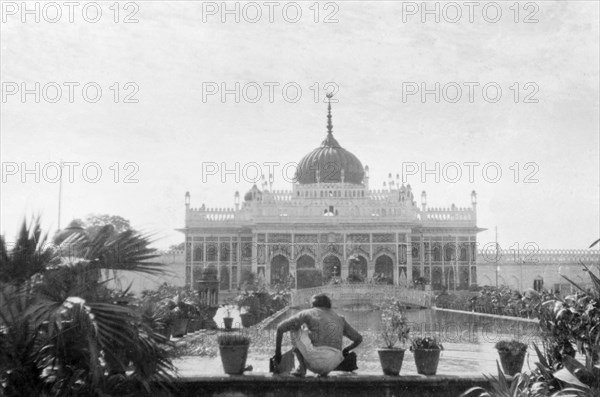 The Chhota Imambara in Lucknow. A figure crouches in front of an ornamental pool at the Chhota Imambara (or Hussainabad Imambara), a Shia Islam mausoleum built by Nawab Muhammad Ali Shah (r.1837-42) in 1837. Lucknow, United Provinces (Uttar Pradesh), India, January 1934. Lucknow, Uttar Pradesh, India, Southern Asia, Asia.
