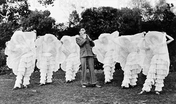 Pantaloon pantomime. Members of the cast of 'Flying Fragments' in hoop skirts, performed by the Moradabad Amateur Dramatic Society at the Railway Institute. The ma in the centre is Reverend B Stratton playing the character of Professor Sparrow-Hawk. Moradabad, United Provinces (Uttar Pradesh), India, 12 February 1934., Uttar Pradesh, India, Southern Asia, Asia.