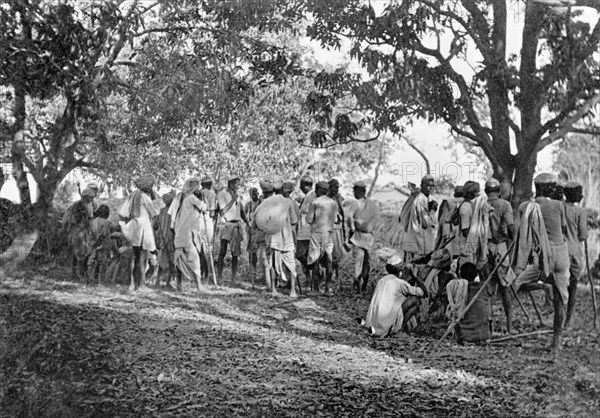 Pig-sticking near Delhi, 1934. A large group of Indian hunters gathers in a forest clearing on a pig-sticking drive to hunt wild boar. Moradabad, United Provinces (Uttar Pradesh), India, February 1934., Delhi, India, Southern Asia, Asia.