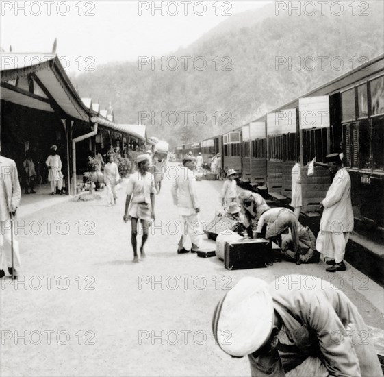 Unloading luggage at Kathgodam railway station. Indian porters help European passengers to unload their luggage from a train on the platform at Kathgodam railway station. Kathgodam, United Provinces (Uttar Pradesh), India, June 1935. Naini Tal, Uttaranchal, India, Southern Asia, Asia.