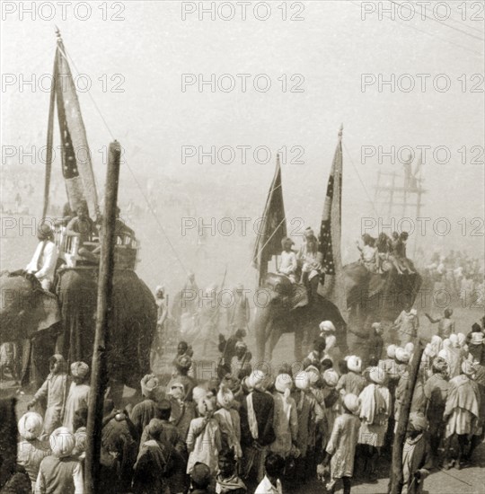 Procession at the Ardh Kumbh Mela. A procession containing elephants and banners passes through crowds of Hindu pilgrims on its way to the Triveni Sangam (the holy confluence of the Yamuna, Saraswati and Ganges Rivers) at the Ardh Kumbh Mela. Allahabad, United Provinces (Uttar Pradesh), India, January 1936. Allahabad, Uttar Pradesh, India, Southern Asia, Asia.