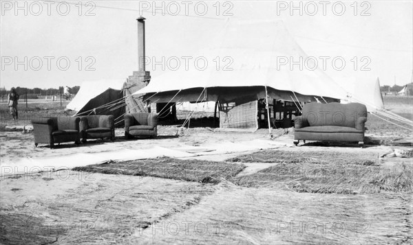 Drying out after a storm. Grass mats and furniture sit outside a large marquee, drying in the sun following a heavy storm at the camp of James Ferguson, Indian Police. United Provinces (Uttar Pradesh), India, 1936., Uttar Pradesh, India, Southern Asia, Asia.