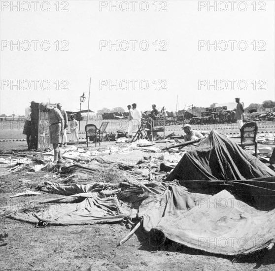 Storm damage at an Indian Police camp. Officers sift through debris at the camp of James Ferguson, Indian Police, trying to salvage useable items after a heavy storm. United Provinces (Uttar Pradesh), India, 1936., Uttar Pradesh, India, Southern Asia, Asia.