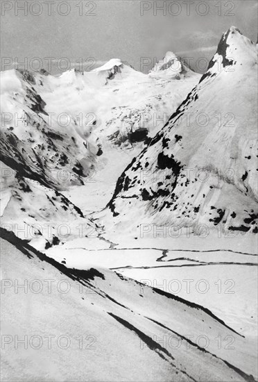 At the peak of Sheshnag Mountain. The snow-capped peaks of Sheshnag Mountain rise up from a valley on the mountain top. JShisham Nag, India, 1934., Jammu and Kashmir, India, Southern Asia, Asia.