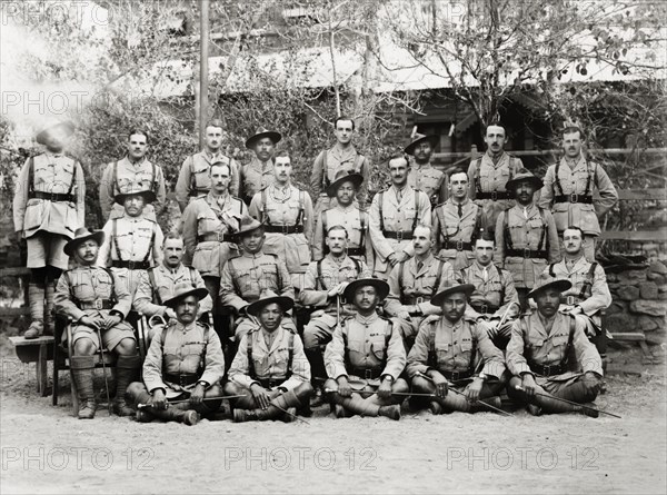 Officers of the Eighth Royal Gurkha Rifles. Asian and European officers of the Eighth Royal Gurkha Rifles pose for a group portrait, dressed in full uniform with marching canes and walking sticks. North West Frontier Province, India (Pakistan), 1920., North West Frontier Province, Pakistan, Southern Asia, Asia.