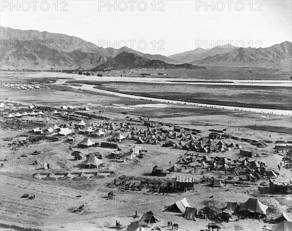 Military camp at Landi Khana. View across an Indian Army camp, located in a mountain valley near the Khyber Pass. Protected by earthworks, the camp contains rows of bell tents and temporary stables for the horses of a cavalry regiment. Landi Khana, North West Frontier Province, India (Federally Administered Tribal Areas, Pakistan), circa 1919. Landi Khana, Federally Administered Tribal Areas, Pakistan, Southern Asia, Asia.