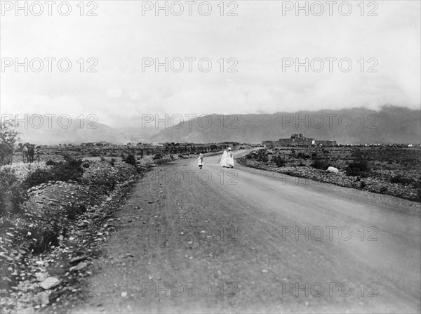 The road to Jamrud Fort. A convoy of camels is led along a road towards Jamrud Fort, a mud fort built by Sikh General Hari Singh Nalwa in 1837. An original caption comments: "The entrance to the (Khyber) Pass is four miles further on (through) the gap in the hills...". Jamrud, North West Frontier Province, India (Pakistan), 1919. Jamrud, North West Frontier Province, Pakistan, Southern Asia, Asia.