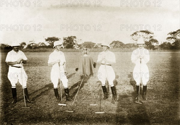 Polo team with Georgian Cup. The Zaria polo team pose for a group portrait with the Georgian Cup at an international event organised by the Nigeria Polo Association. The award was presented to the team by the Bank of British West Africa (now First Bank Plc.). Zaria, Nigeria, November 1920. Zaria, Kaduna, Nigeria, Western Africa, Africa.