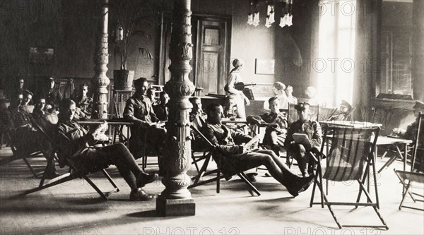The British Empire Leave Club at Cologne. British Army officers relax in deckchairs inside the British Empire Leave Club at Cologne. The club provided accommodation for British and colonial soldiers in the Rhine and was opened in May 1919 by English singer and actress, Lillian Decima Moore-Guggisberg, the director of several similar leave clubs in France. Cologne, Germany, circa 1919. Cologne, Germany, Germany, Central Europe, Europe .