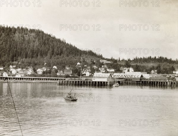 Wrangell pier, Alaska. A wooden pier stretches into the waters of the Zimovia Strait at the coastal town of Wrangell. Wrangell, Alaska, United States of America, circa 1931. Wrangell, Alaska, United States of America, North America, North America .