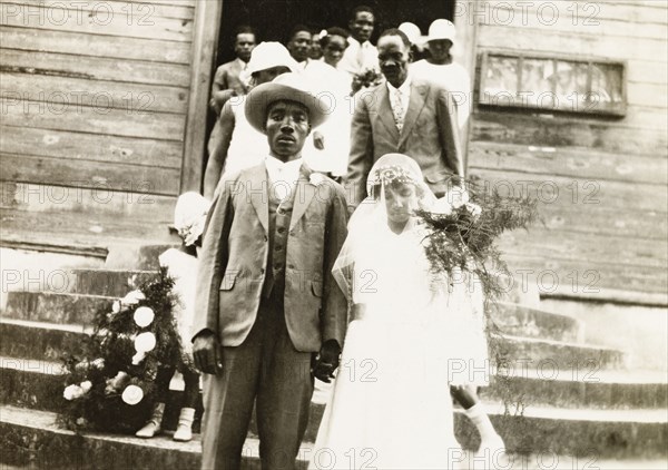 A newlywed Trinidadian couple. A newlywed Trinidadian couple descend the church steps after their wedding ceremony. Siparia, Trinidad, circa 1931. Siparia, Trinidad and Tobago, Trinidad and Tobago, Caribbean, North America .