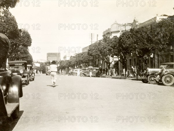 City street in Natal, Brazil. Pedestrians mill about on a wide, tree-lined street in the centre of Natal. Natal, Rio Grande do Norte, Brazil, circa 1931. Natal, Brazil, Brazil, South America, South America .