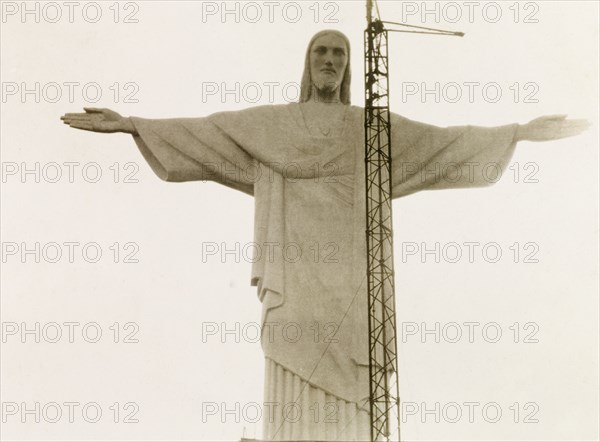 Christ the Redeemer, Rio de Janeiro. Rio de Janeiro's landmark statue of Christ the Redeemer, pictured around the time of its inauguration on 12 October 1931. Designed in Art Deco style by Polish-French sculptor Paul Landowski, the statue is 710 metres tall and stands atop Corcovado Mountain overlooking the city. Rio de Janeiro, Brazil, circa 1931. Rio de Janeiro, Brazil, Brazil, South America, South America .