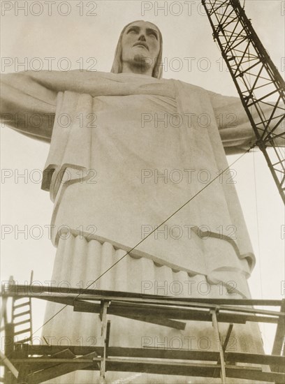 Christ the Redeemer, Rio de Janeiro. Rio de Janeiro's landmark statue of Christ the Redeemer, pictured around the time of its inauguration on 12 October 1931. Designed in Art Deco style by Polish-French sculptor Paul Landowski, the statue is 710 metres tall and stands atop Corcovado Mountain overlooking the city. Rio de Janeiro, Brazil, circa 1931. Rio de Janeiro, Brazil, Brazil, South America, South America .