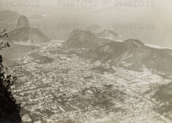 Rio de Janeiro, Brazil. View taken from the peak Corcovado Mountain, looking out across the sprawling city of Rio de Janeiro towards the Atlantic Ocean. Rio de Janeiro, Brazil, circa 1931. Rio de Janeiro, Brazil, Brazil, South America, South America .