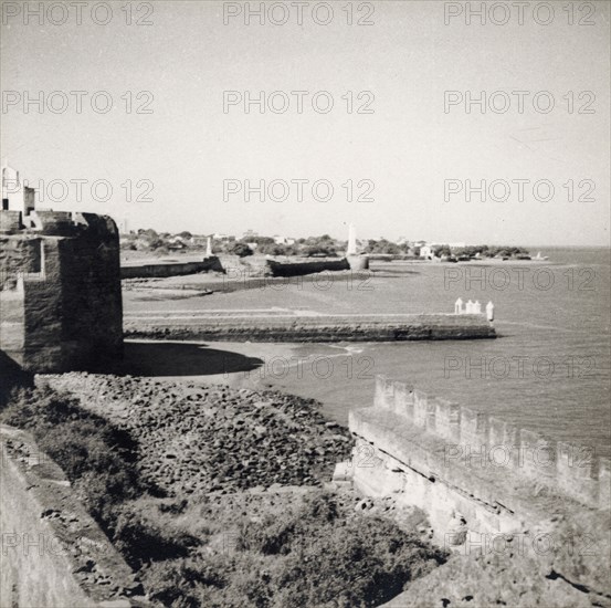 A breakwater on Diu Island. A breakwater extends into the sea from the old fort on Diu island, built by the Portuguese during the mid 16th century. Diu Island, Daman and Diu, India, circa 1937. Diu, Daman and Diu, India, Southern Asia, Asia.