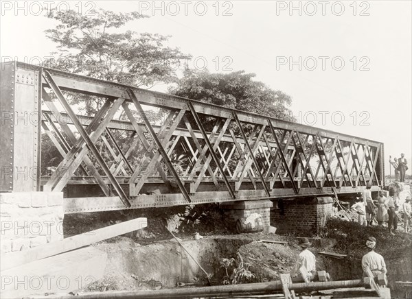 Building a railway bridge near the Caroni River. Construction workers build a 24-metre railway bridge close to the Caroni River to prevent flooding on a nearby extension line of the Trinidad Government Railway. Caroni, Trinidad, circa 1912. Caroni, Trinidad and Tobago, Trinidad and Tobago, Caribbean, North America .