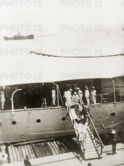 Negus Selassie arrives in Palestine. Negus (Emperor) Haile Selassie I (1892-1975) of Ethiopia disembarks from a boat at a Palestinian port, accompanied by British Navy personnel. Forced into exile in Britain following Italy's invasion of Ethiopia in 1936, Selassie also spent extended periods in Jerusalem. Probably Haifa, British Mandate of Palestine (Israel), circa 1938. Haifa, Haifa, Israel, Middle East, Asia.