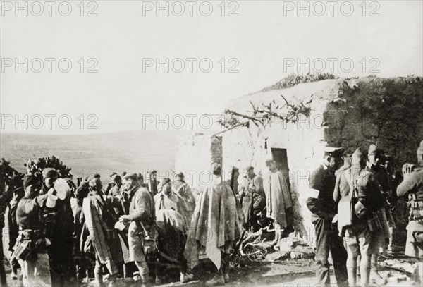 Troops at a village in Samaria. British and Arab soldiers and police gather outside a village dwelling during operations in the region of Samaria. During the period of the Great Uprising (1936-39), an additional 20,000 British troops were deployed to Palestine in an attempt to clamp down on Arab dissidence. Tilfit, British Mandate of Palestine (West Bank, Middle East), 1938., West Bank, West Bank (Palestine), Middle East, Asia.