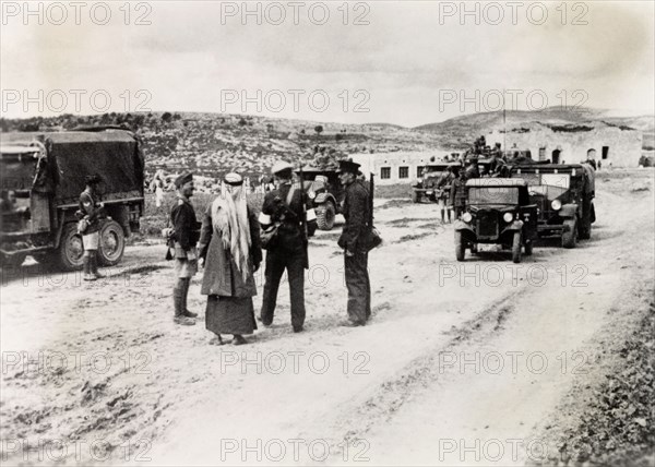 Patrolling a border checkpoint in Arabah. Armed British and Arab police officers patrol a border checkpoint in Arabah during the Great Uprising (1936-39). Arabah, British Mandate of Palestine-Transjordan (Israel-Jordan), circa 1938. Israel, Middle East, Asia.