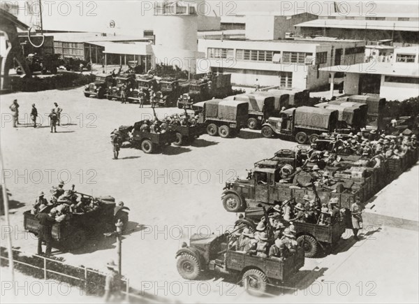 Border guards leave the Levant Fair. Armed border guards climb into their open-topped jeeps as they prepare to leave the Levant Fair exhibition ground. During the period of the Great Uprising (1936-39), an additional 20,000 British troops were deployed to Palestine in an attempt to clamp down on Arab dissidence. Tel Aviv, British Mandate of Palestine (Israel), circa 1938., Tel Aviv, Israel, Middle East, Asia.
