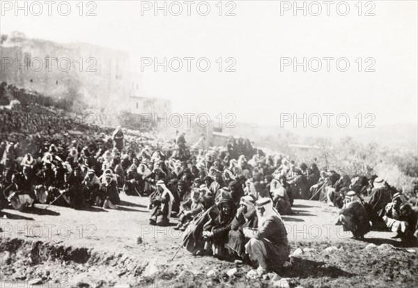 Searching a Palestinian village. The inhabitants of Al Sita are detained outdoors whilst British troops search the village for evidence of rebel activity. During the period of the Great Uprising (1936-39), an additional 20,000 British troops were deployed to Palestine in an attempt to clamp down on Arab dissidence. Al Sita, British Mandate of Palestine (Middle East), circa 1938., Middle East, Asia.