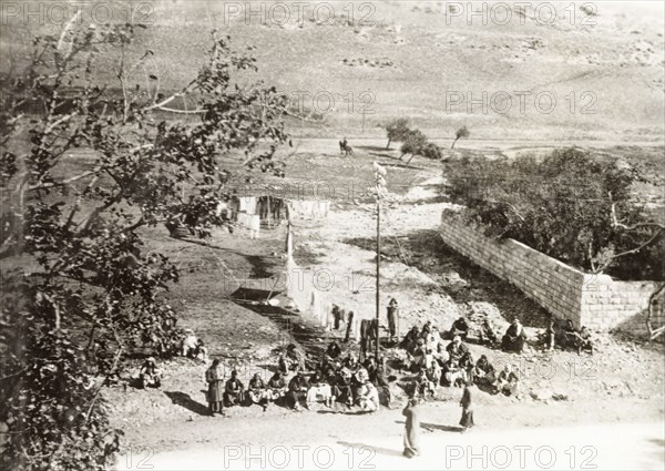 Arab detainees oppositie Nablus Fort. Arab detainees sit on the roadside opposite Nablus Fort. An original caption suggests they are awaiting court martial from the British Army, who were attempting to clamp down on Arab dissidence during the Great Uprising (1936-39). Nablus, British Mandate of Palestine (West Bank, Middle East), circa 1938. Nablus, West Bank, West Bank (Palestine), Middle East, Asia.