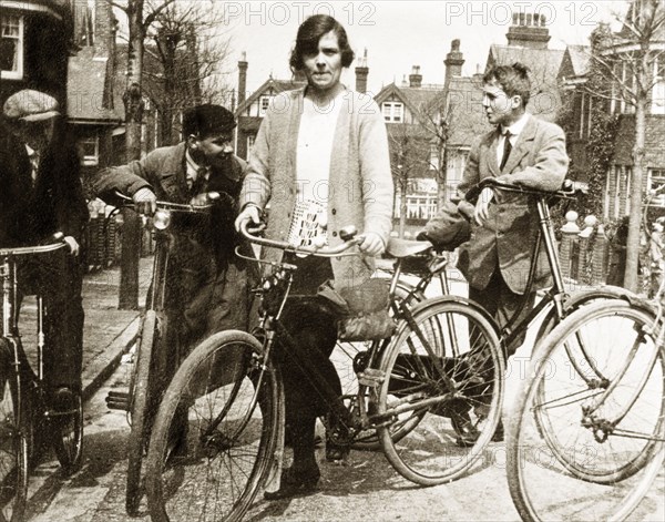 Cycling in Eastbourne. Enid Murray and several young men lean on their bicycles on a suburban street in Eastbourne. Eastbourne, England, 1922. Eastbourne, Sussex, England (United Kingdom), Western Europe, Europe .