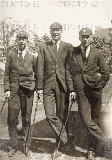 Eastbourne College students. Three male students of Eastbourne College, identified as Frearson, MacIntosh and Strong, lean on walking sticks as they pose for the camera in their school uniforms. Eastbourne, England, circa 1923. Eastbourne, Sussex, England (United Kingdom), Western Europe, Europe .
