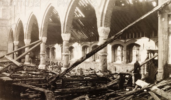 Interior of a fire damaged church. Interior shot of All Saints Church in Eastbourne in the aftermath of a devastating fire. The building's stone aisle arches remain undamaged amidst a tangled mess of charred roof beams, which lie strewn about on the church floor. Eastbourne, England, 1926. Eastbourne, Sussex, England (United Kingdom), Western Europe, Europe .