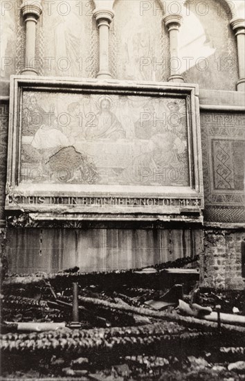 Fire damaged painting in All Saints Church. Interior shot of All Saints Church in Eastbourne in the aftermath of a devastating fire. A fire damaged painting depicting Jesus' Last Supper hangs on a stone wall amidst the charred ruins. Eastbourne, England, 1926. Eastbourne, Sussex, England (United Kingdom), Western Europe, Europe .