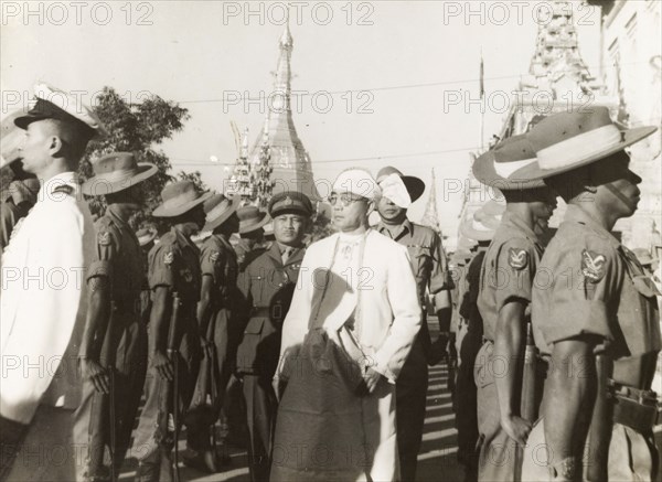 Sao Shwe Thaik inspects. Saopha Sao Shwe Thaik, a Shan Chief and the first independent President of Burma, inspects a line up of Burma Army soldiers who stand to attention with rifles. The short man behind him may be Smith Dun, a Karen military officer who became the first Chief of Armed Forces in independent Burma. Probably Rangoon (Yangon), Burma (Myanmar), circa August 1948. Yangon, Yangon, Burma (Myanmar), South East Asia, Asia.