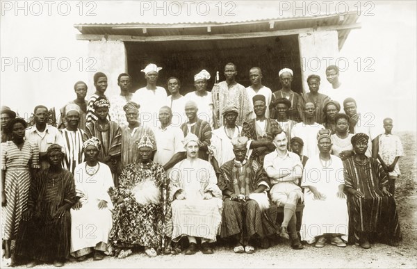 Imesi Progressive Union. British colonial officer Cyril Iles sits proudly at the centre of a group portrait, wearing the traditional dress of an African chief: "clearly a great occasion and an honour". He is surrounded by African members of the Imesi Progressive Union. Imesi-Ile, Nigeria, 8 January 1953. Imesi-Ile, Osun, Nigeria, Western Africa, Africa.